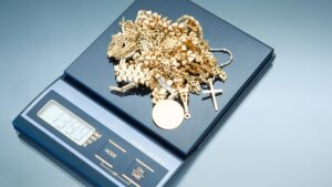 Weighing gold to determine the weight and ultimately the price for selling jewelry
