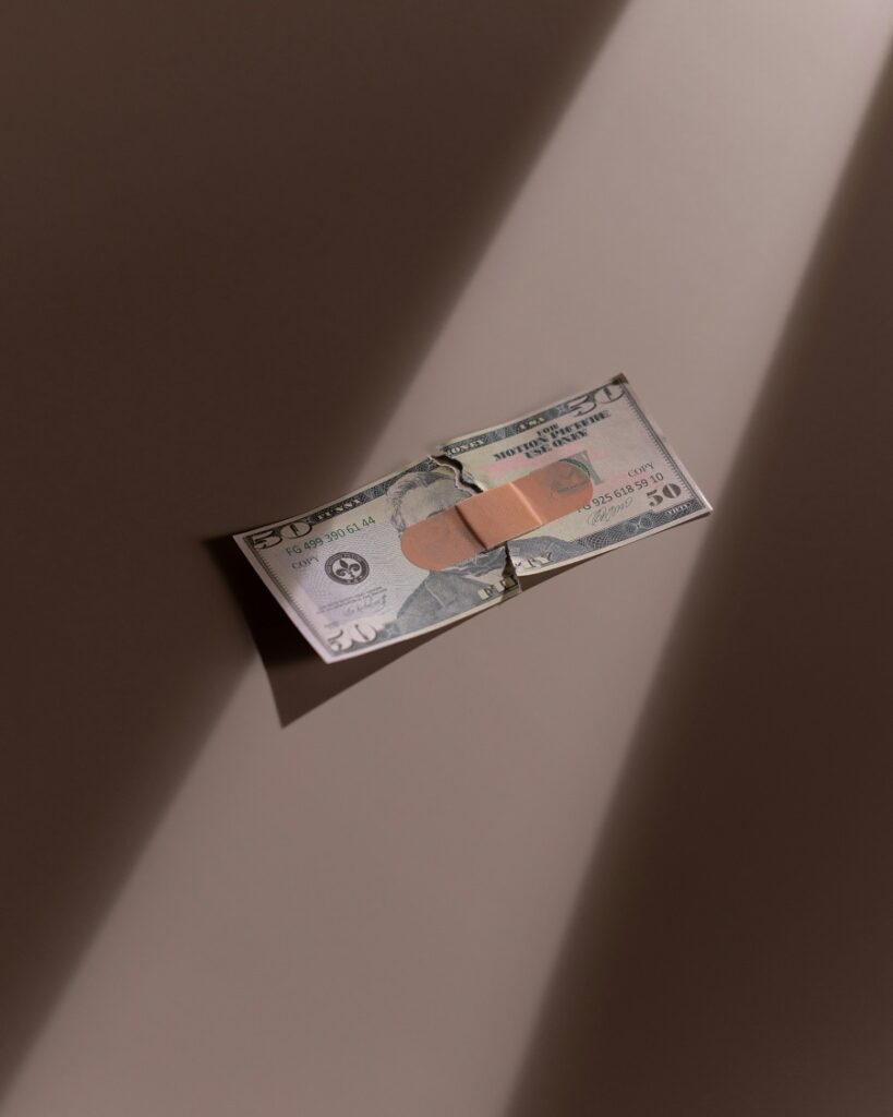 Hidden fees when selling you gold can hurt your money, just as the money with the plaster on the picture